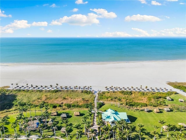 drone / aerial view with a water view and a beach view