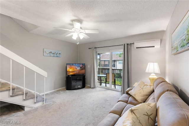 carpeted living room with a textured ceiling, ceiling fan, and a wall mounted air conditioner