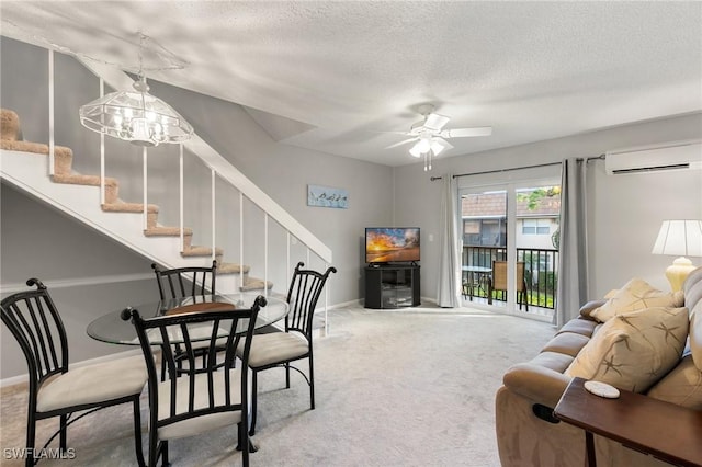 living room with a textured ceiling, carpet flooring, ceiling fan with notable chandelier, and an AC wall unit