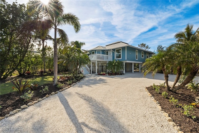 beach home with a porch and a carport