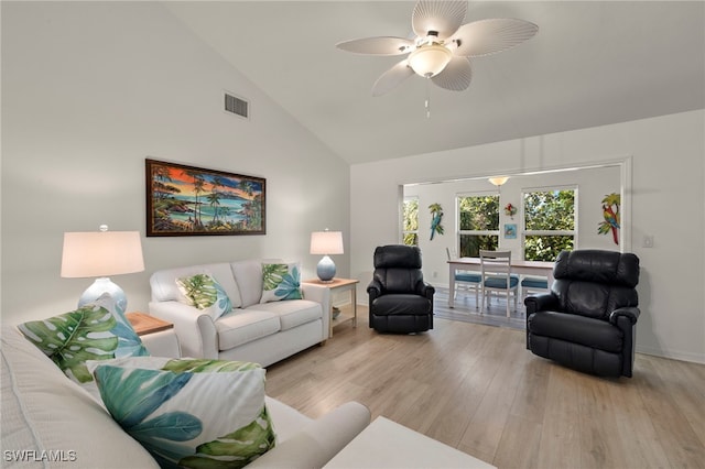 living room with ceiling fan, high vaulted ceiling, and light hardwood / wood-style flooring