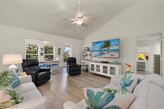 living room featuring high vaulted ceiling, light hardwood / wood-style floors, and ceiling fan