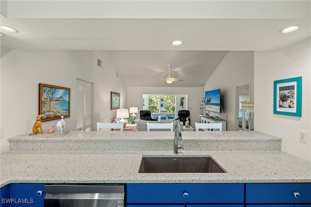 kitchen with lofted ceiling, sink, and blue cabinetry