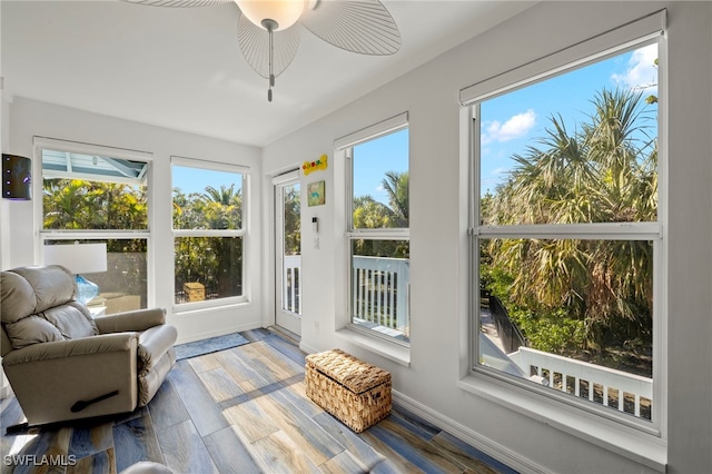 sunroom featuring ceiling fan