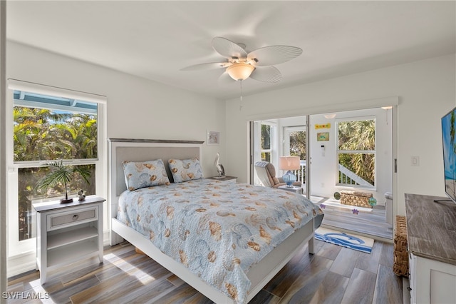 bedroom with dark hardwood / wood-style flooring and ceiling fan