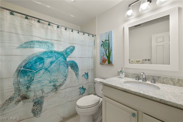 bathroom featuring vanity, a shower with shower curtain, and toilet