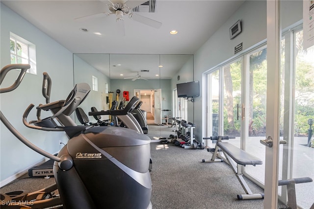 gym with ceiling fan, carpet, and a healthy amount of sunlight