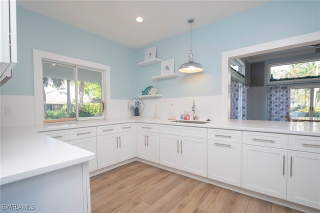 kitchen with white cabinets, a healthy amount of sunlight, and sink