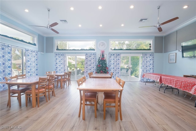 dining space featuring a wealth of natural light, light hardwood / wood-style flooring, and crown molding