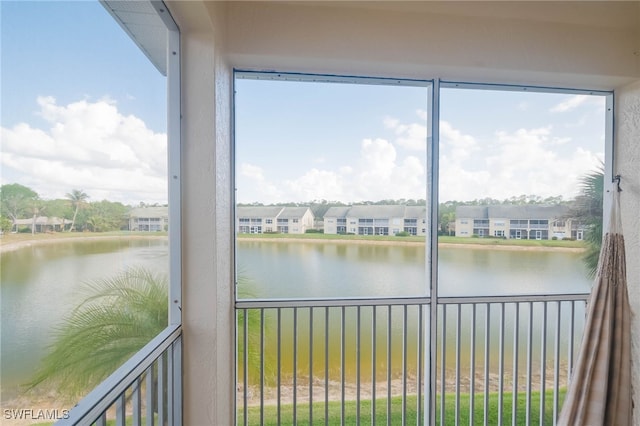 unfurnished sunroom with a water view