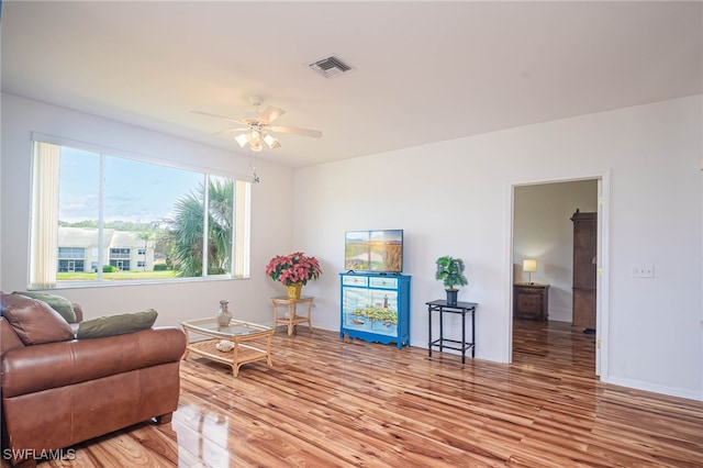 sitting room featuring hardwood / wood-style floors and ceiling fan