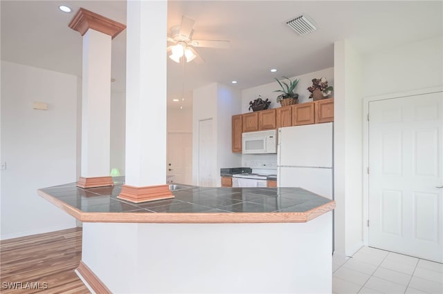 kitchen featuring ceiling fan, white appliances, kitchen peninsula, and light hardwood / wood-style flooring