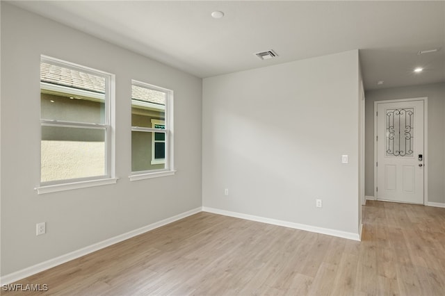 unfurnished room featuring light hardwood / wood-style floors