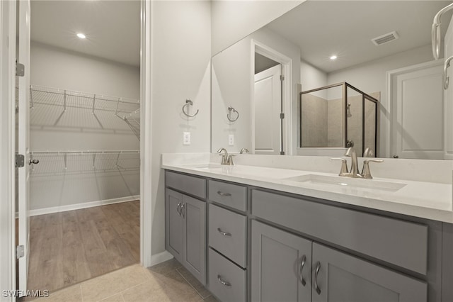 bathroom with vanity, tile patterned floors, and an enclosed shower