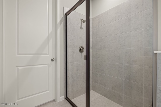 bathroom featuring a shower with door