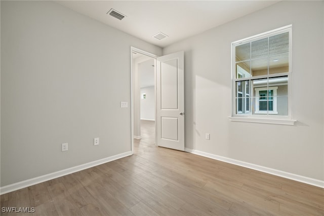 spare room with light wood-type flooring