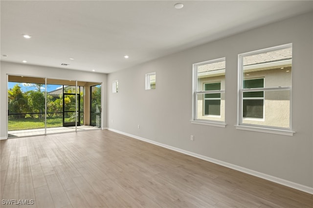 spare room featuring light wood-type flooring