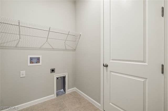 clothes washing area featuring hookup for an electric dryer, hookup for a washing machine, and light tile patterned flooring