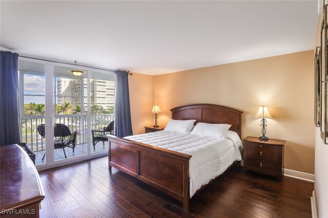 bedroom with access to exterior and dark hardwood / wood-style flooring