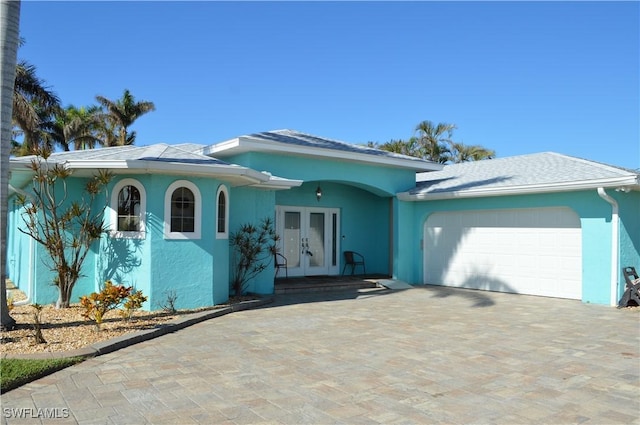 single story home with french doors and a garage