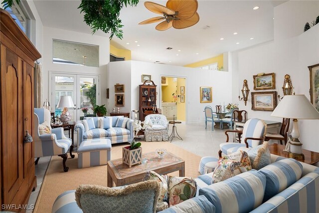 living room featuring a towering ceiling and ceiling fan