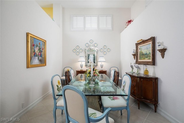 dining area featuring light tile patterned floors and baseboards