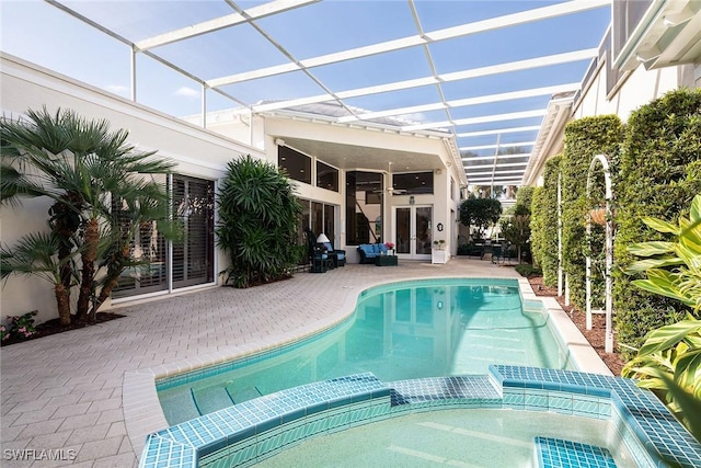 view of swimming pool with an in ground hot tub, french doors, a patio, and a lanai