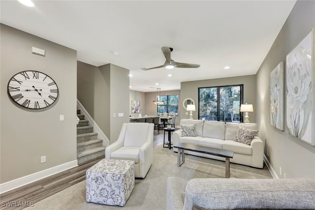 living room with ceiling fan and light hardwood / wood-style floors