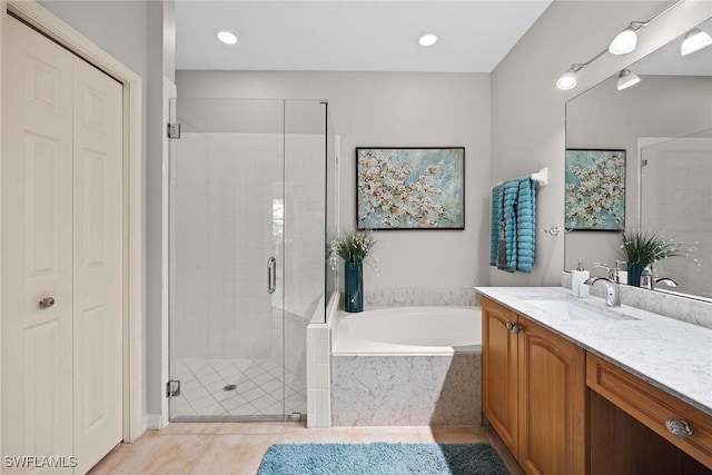 bathroom featuring tile patterned flooring, vanity, and separate shower and tub