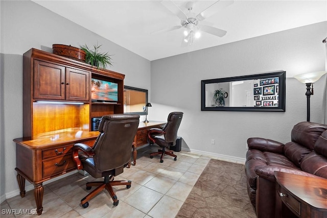 tiled office with ceiling fan and vaulted ceiling