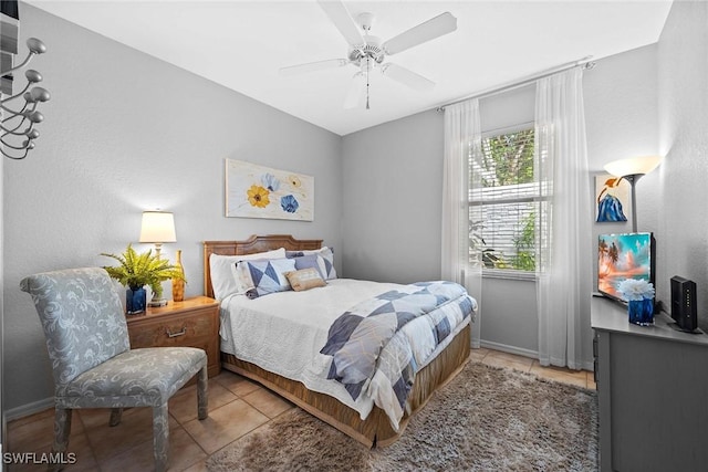 tiled bedroom featuring ceiling fan