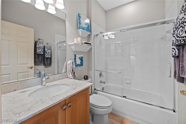 full bathroom featuring tile patterned floors, vanity, toilet, and combined bath / shower with glass door