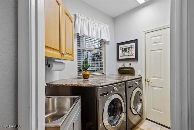 clothes washing area with cabinets, separate washer and dryer, sink, and light tile patterned floors