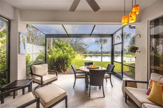 sunroom with a water view and ceiling fan