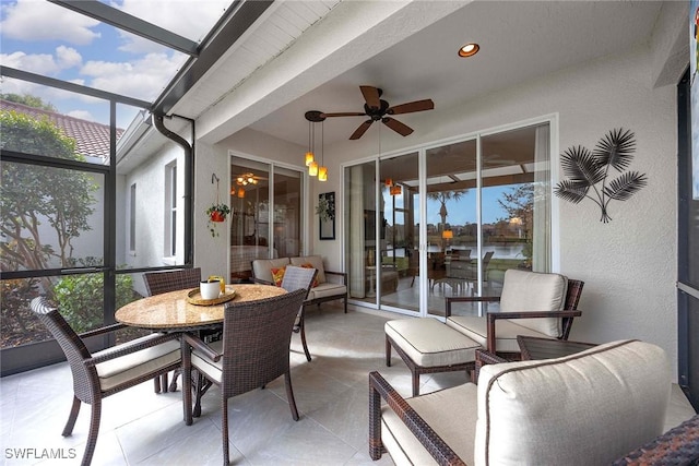 sunroom featuring ceiling fan