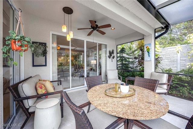 sunroom / solarium with plenty of natural light and ceiling fan