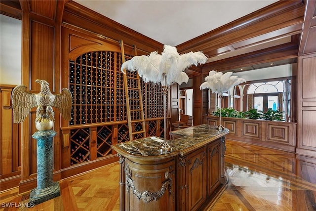 wine area featuring light parquet flooring and ornamental molding