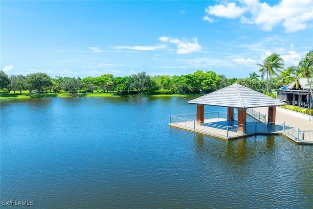 view of dock with a gazebo and a water view