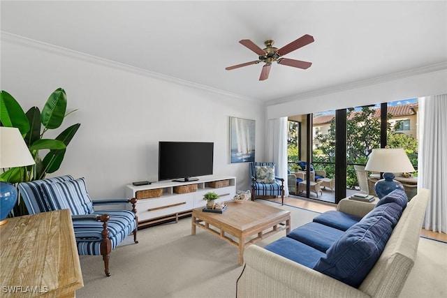 carpeted living room featuring ceiling fan and ornamental molding