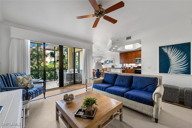 living room featuring ceiling fan and crown molding