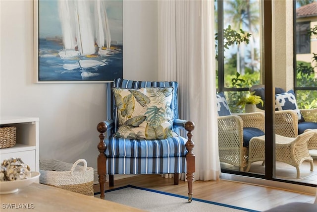 sitting room with wood-type flooring