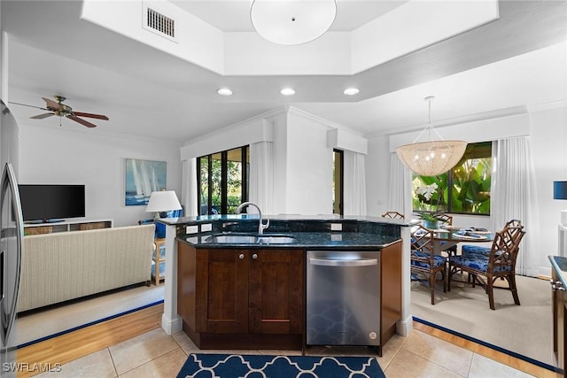 kitchen featuring ceiling fan, dishwasher, sink, hanging light fixtures, and light tile patterned flooring