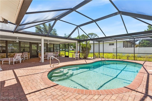 view of swimming pool featuring a patio, a lanai, and ceiling fan