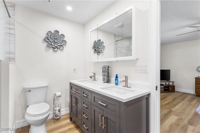 bathroom with hardwood / wood-style flooring, vanity, and toilet