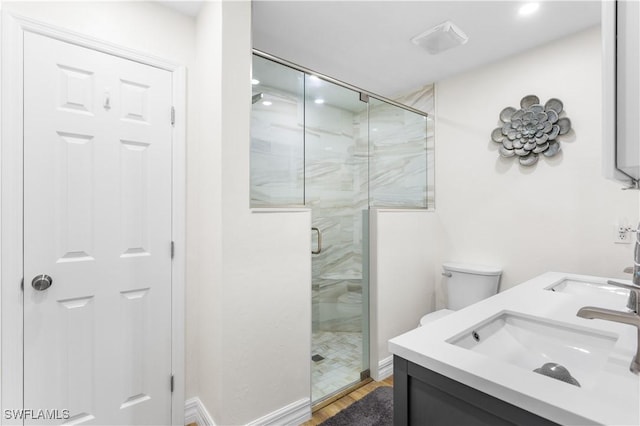 bathroom featuring an enclosed shower, vanity, hardwood / wood-style flooring, and toilet