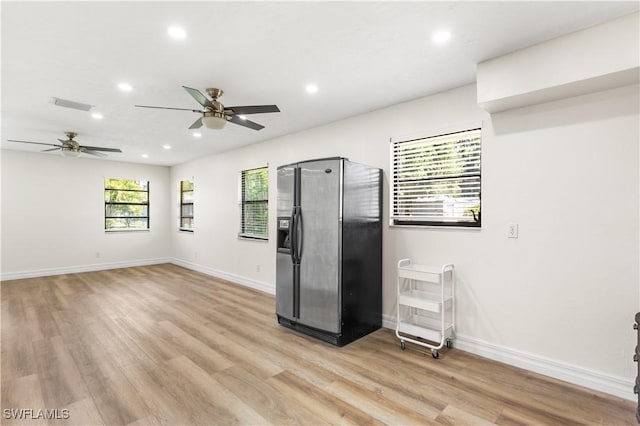 empty room featuring ceiling fan and light hardwood / wood-style flooring