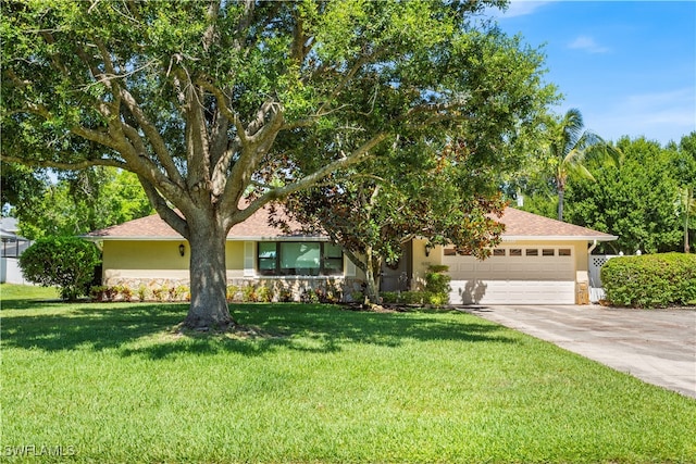 view of front facade featuring a garage and a front lawn