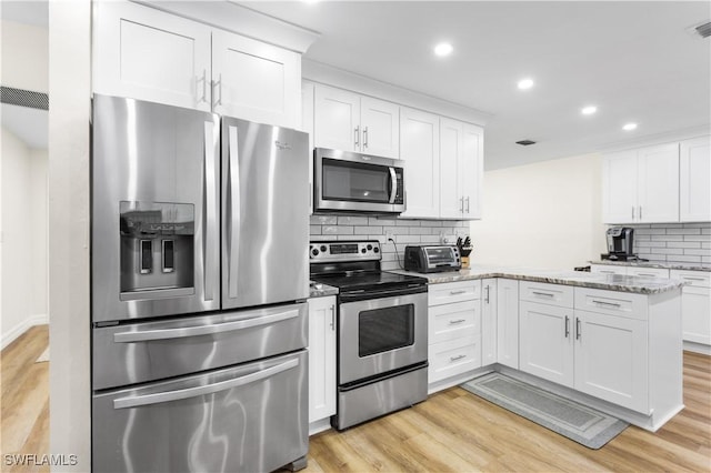 kitchen with white cabinetry, light stone countertops, stainless steel appliances, and light hardwood / wood-style flooring