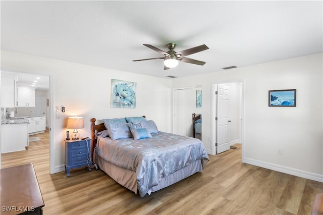 bedroom with a closet, ceiling fan, and light hardwood / wood-style flooring