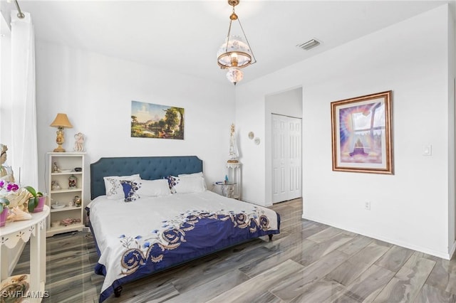 bedroom featuring hardwood / wood-style floors and a closet